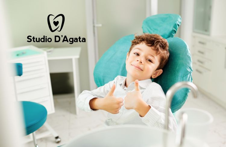 Bambino che alza i pollici perché è stato coraggioso dal dentista